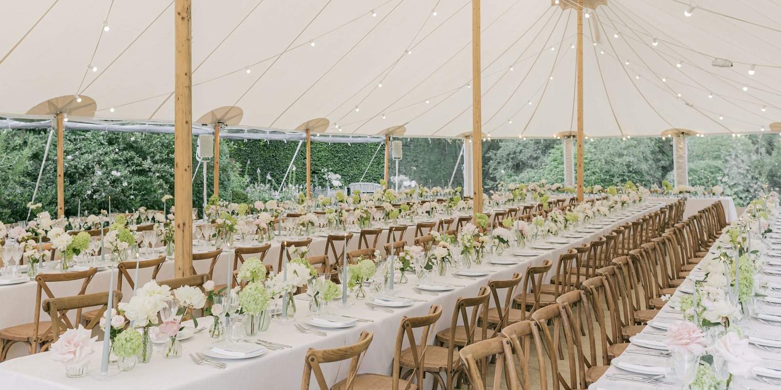A sailcloth marquee lit at dusk
